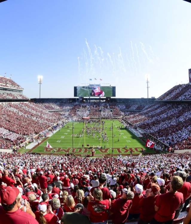 A fisheye image of an OU football game showing the entire stadium of fans from one end of the field