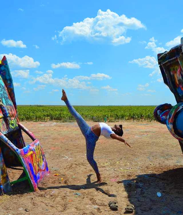 woman doing ballet pose at cadillac ranch in Amarillo, texas