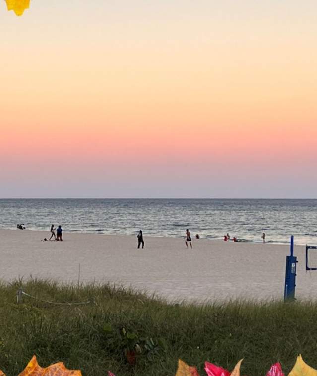 Full Moon Rising on the Beach with a colorful fall leaf frame around it.