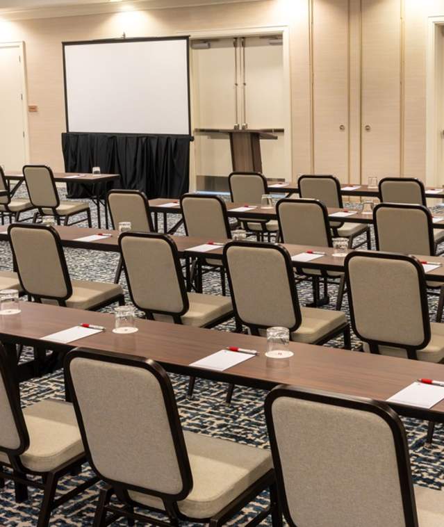 Fort Lauderdale Marriott Pompano Beach Meeting Room set up in classroom style with two screens at the front of the room.