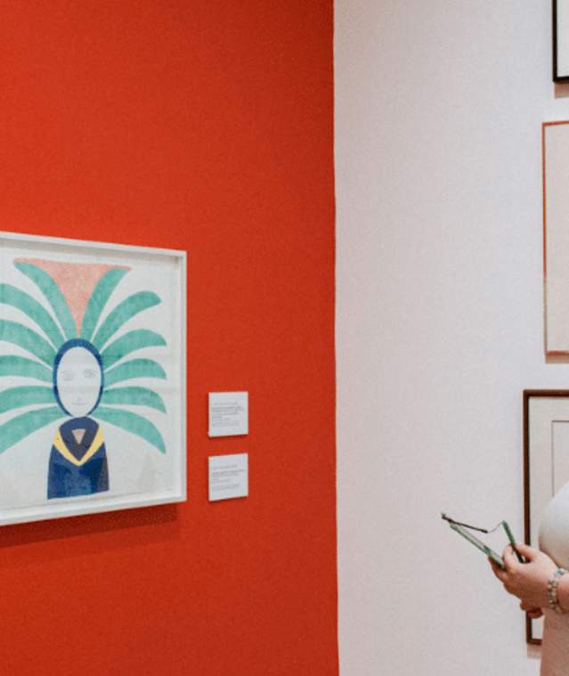 woman in headphones looking at art