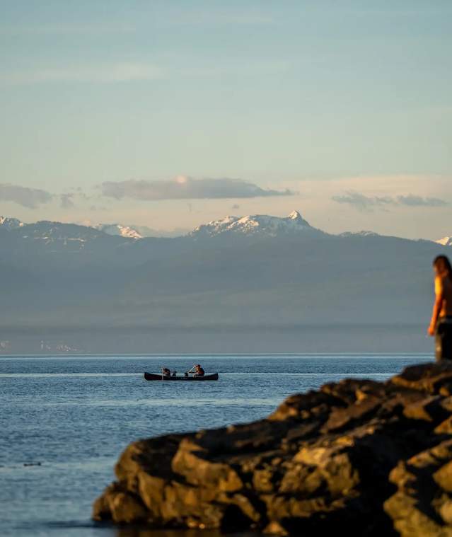 Person-standing-on-rocks-looking