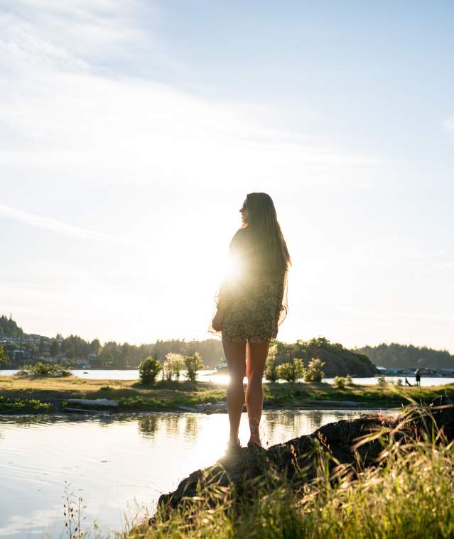 Person standing backlit in the sun on Nanaimo beach/waterfront