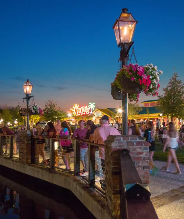 Crowd Walking Barefoot Walkway at Night