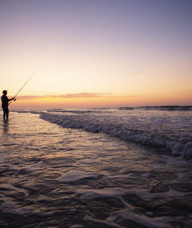 Man fishing at sunset at North Myrtle Beach