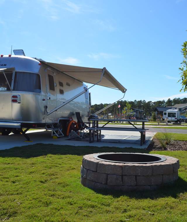 Trailer in Front of Firepit at Carolina Pines RV Site