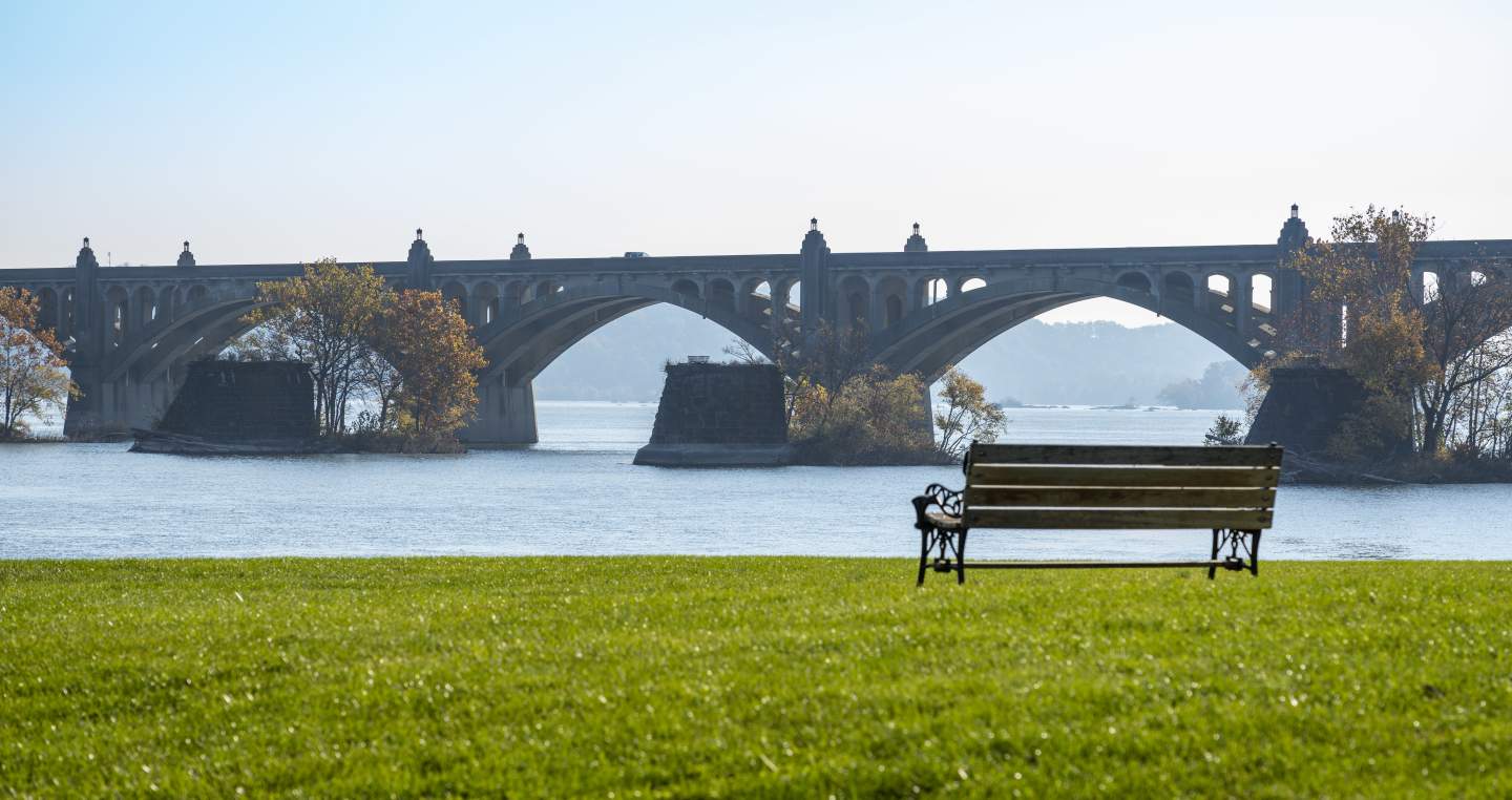 a bench placed right next to the beautiful riverbank of the Susquehanna