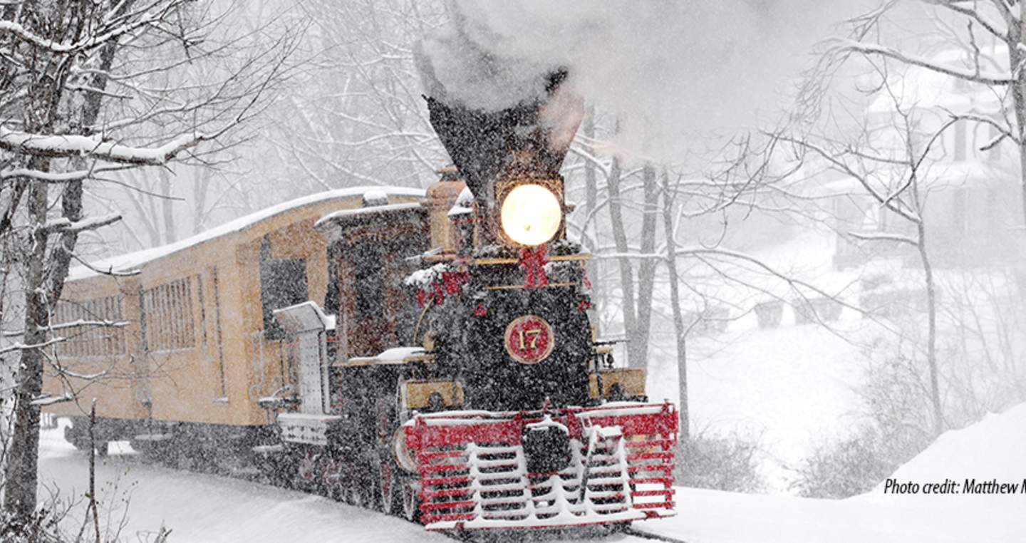 Steam engine making its way through a snowy landscape