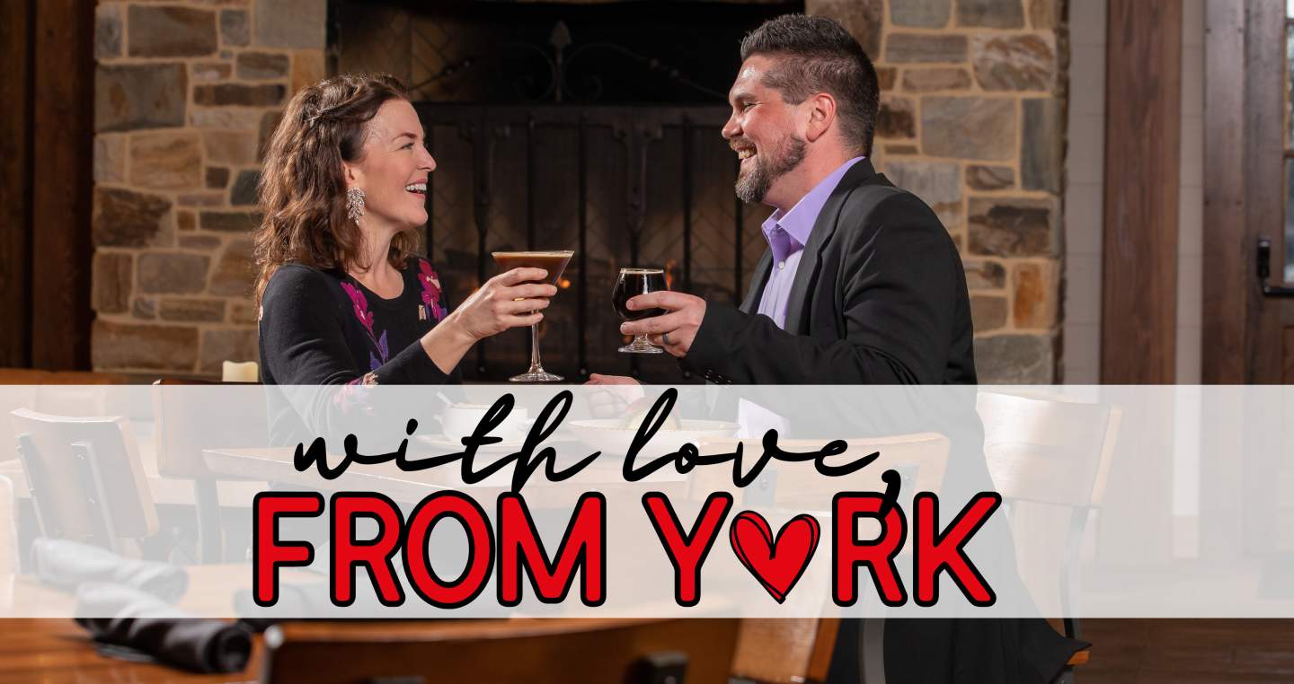 a couple enjoying a laugh over some drinks on date night