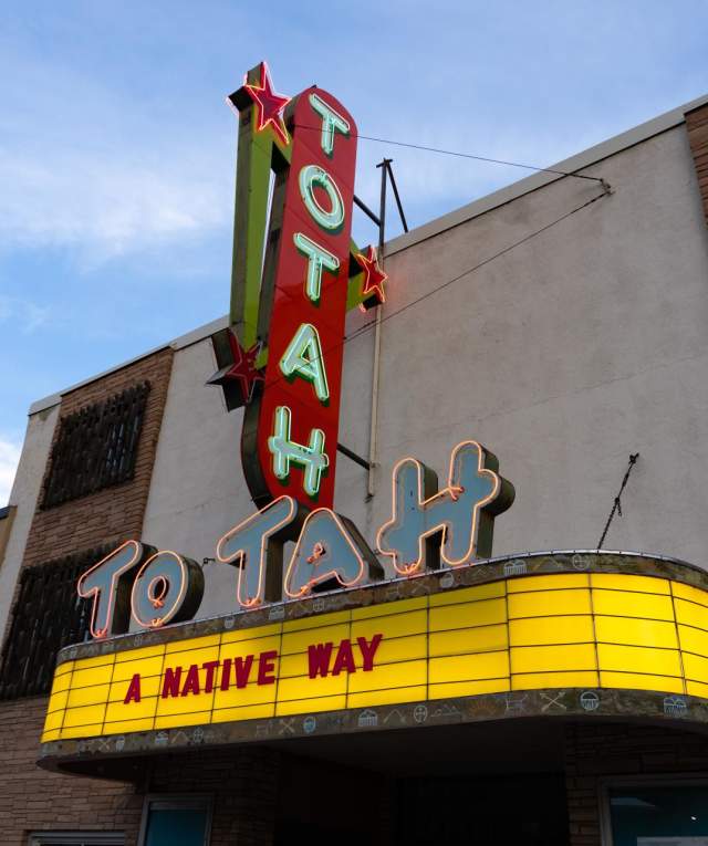 a traditional neon sign that reads Totah above a theater sign that reads "A Native Way"