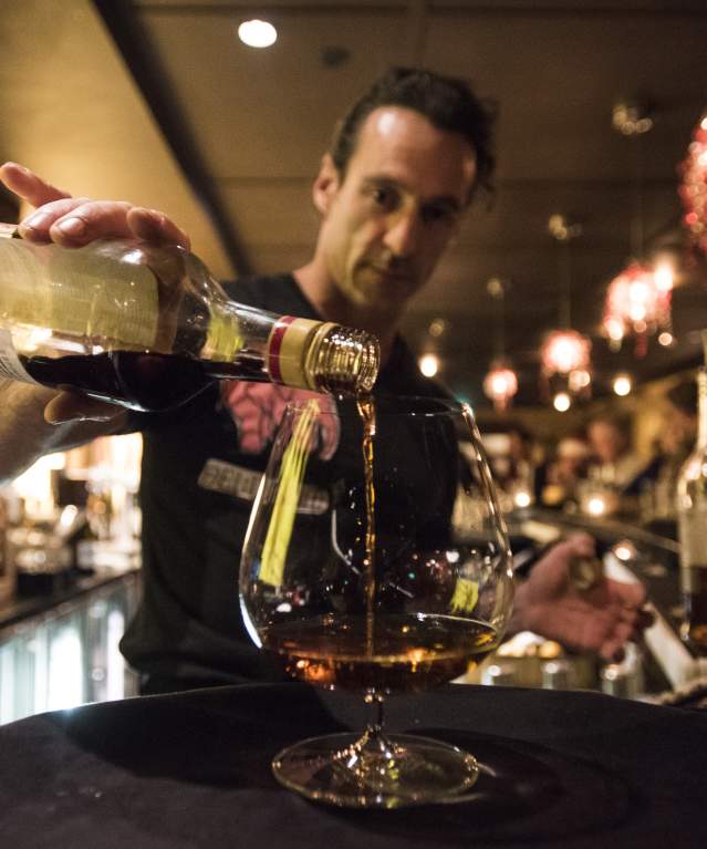 Bartender Pouring A Drink During Happy Hour At Ace Gilletts In Fort Collins, CO