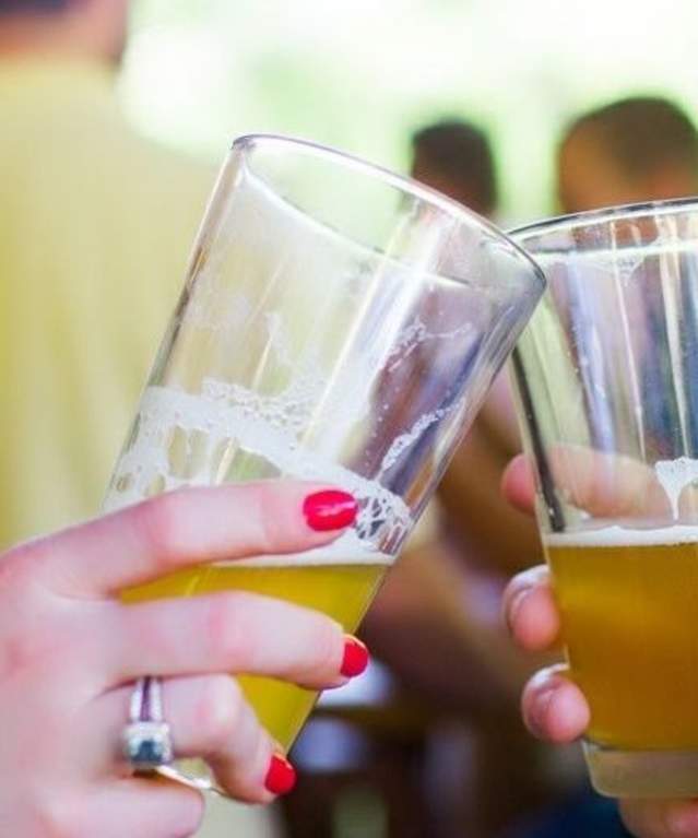 Hands holding pint glasses of beer
