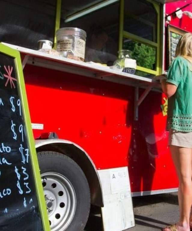 Woman ordering food from a food truck