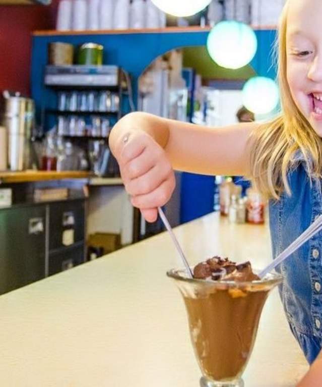 child eating an ice cream sundae