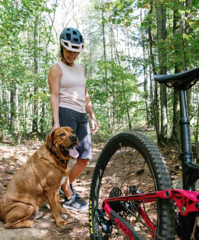 Mountain biker with her dog at Gurney Lane Mountain Bike Park