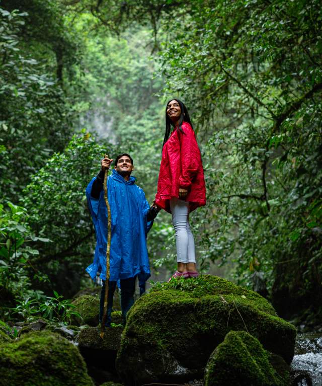 A couple embraced by the misty embrace of the cloud forest in the highlands of Volcán.