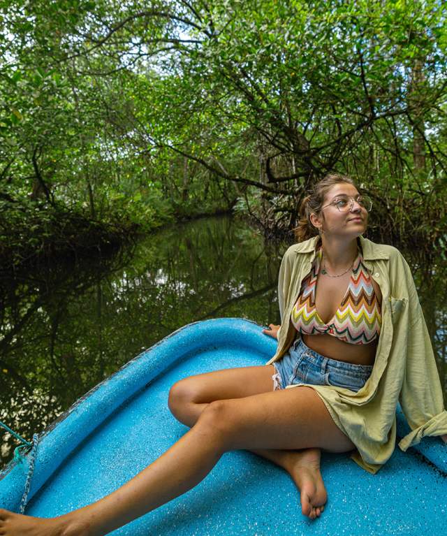 Woman on a boat admiring the nature on Bastimentos National Marine Park
