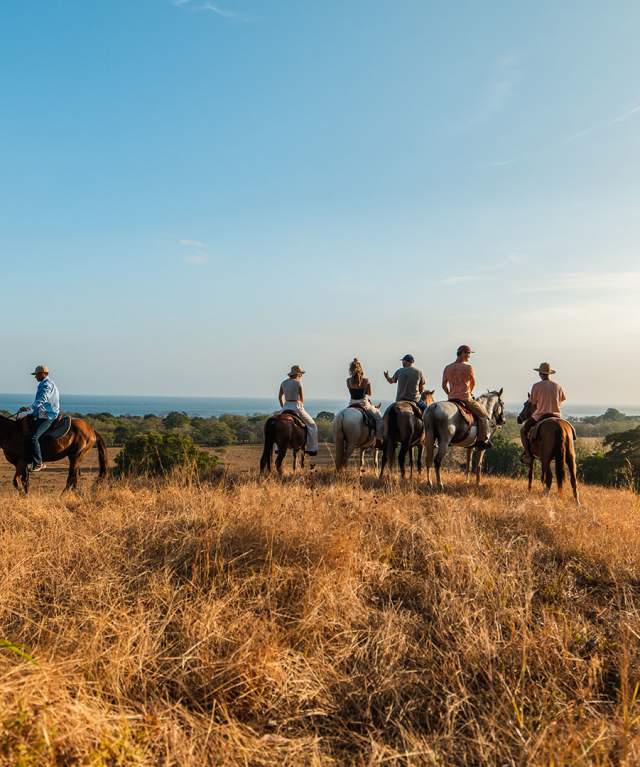 Group of tourist horse riding at Cambutal on a clear day, Los Santos province
