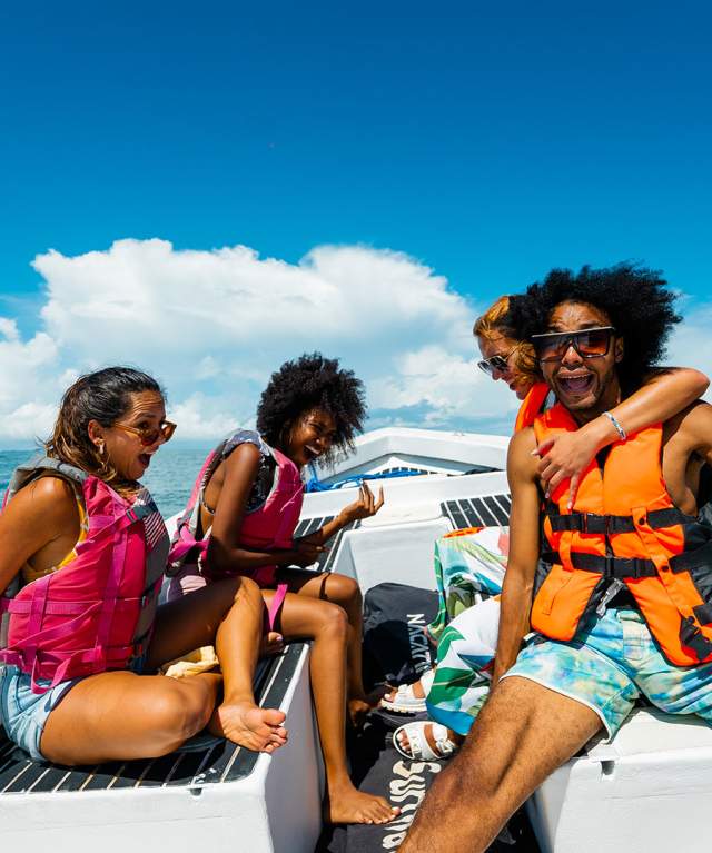 Friends enjoying a beautiful sunny day on a boat on the beaches of the Gulf of Chiriqui