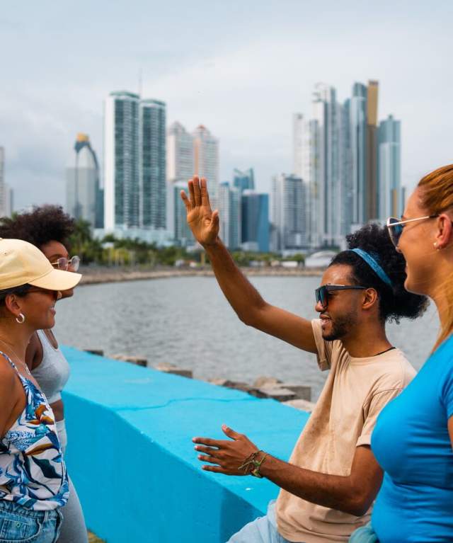 Friends enjoying at Cinta Costera, in the background you can see the skyline of Panama City, Panamá