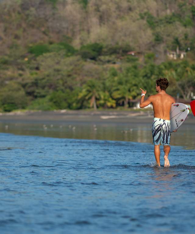 Couple of surfers walking at Playa Venao, Los Santos province, Panamá