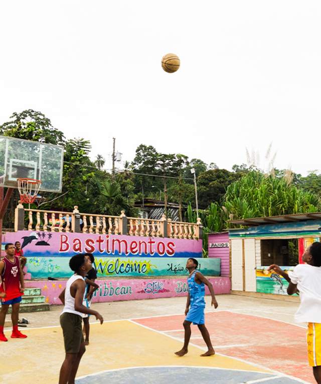 Group playing on a basketball rural court