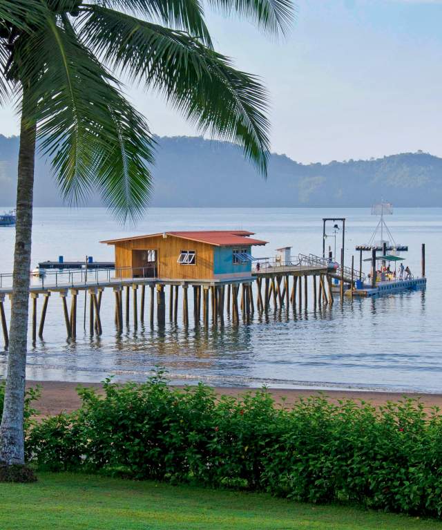 Sport fishing dock in Bahia Piñas with boats and jungle-covered hills in Darien Province, Panama.