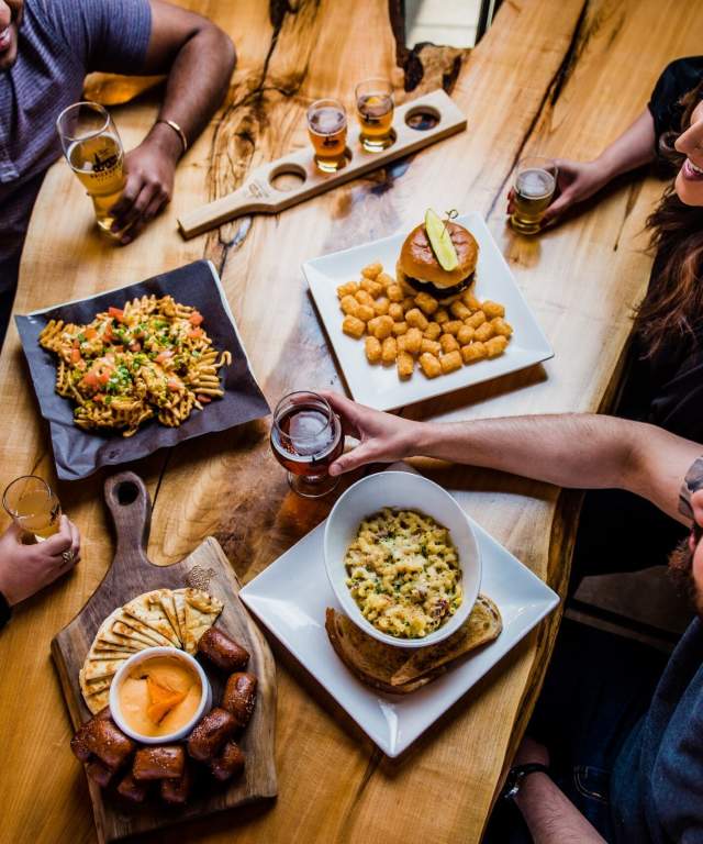 aerial of a table of food with people sitting around
