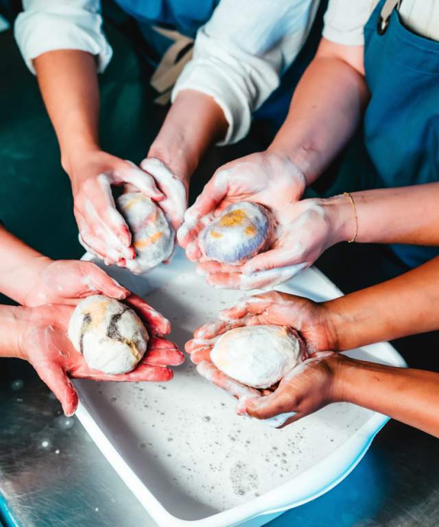 People creating soap souvenirs