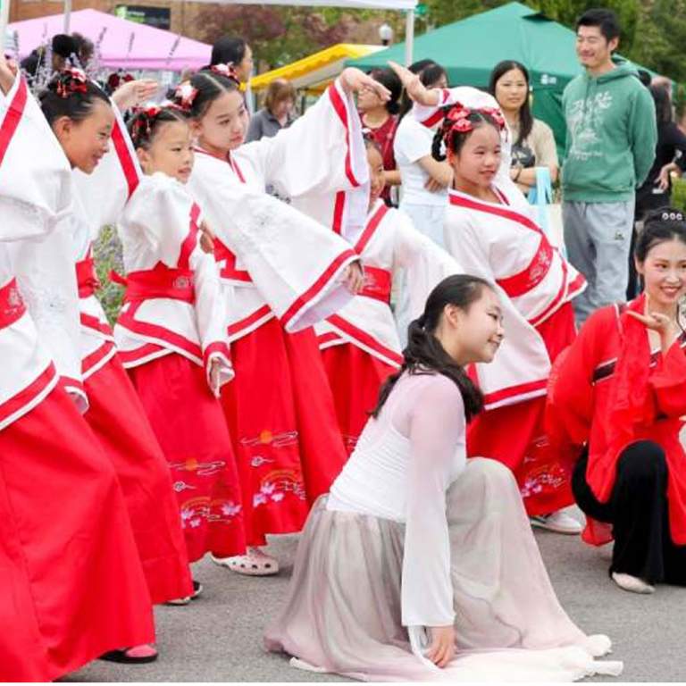 Chinese and Mexican dance performances during 2025 Welcoming Week festivities. Attendees hugging during networking portion of 2025 Welcoming Fort Wayne Awards.