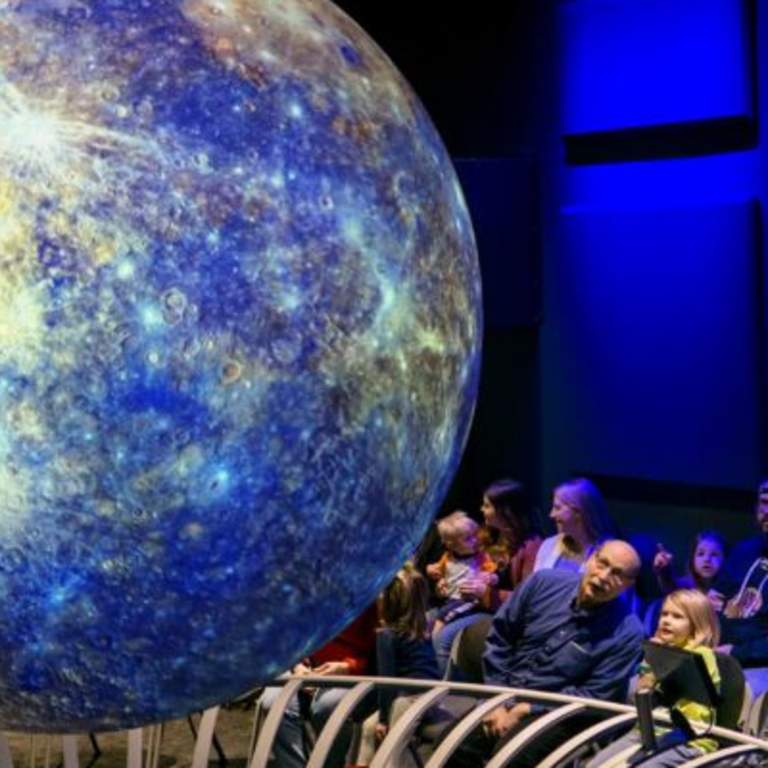 Visitors at Science Central watch a model of Earth at the Science on a Sphere display. Earth Day at Science Central is 4/26/2026