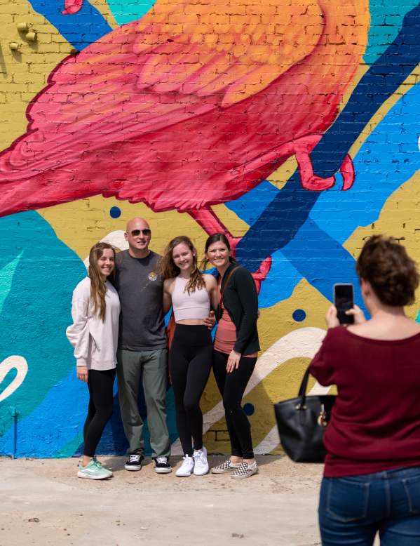 Family taking pictures and experiencing the fun at the Mural Festival in Beaumont, Texas!