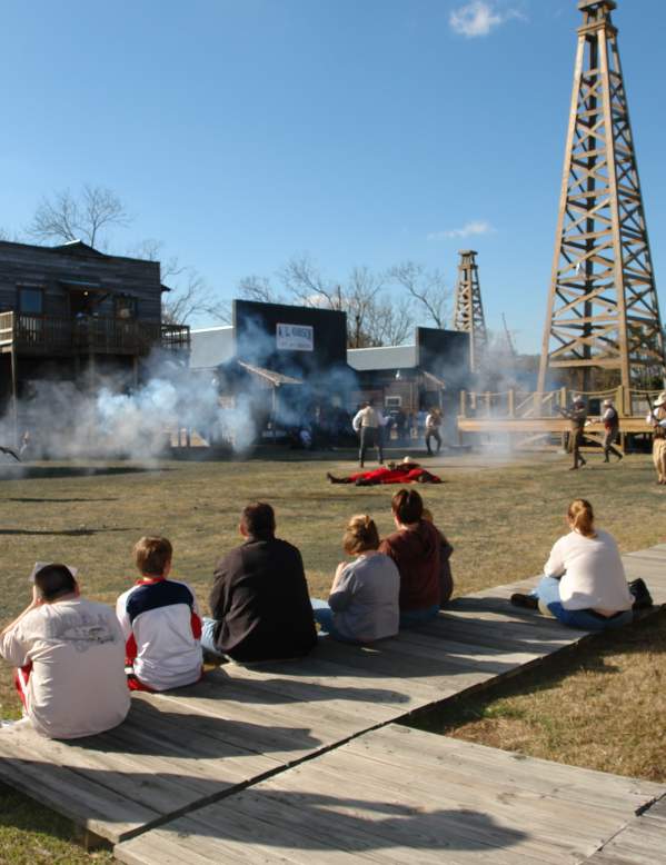 Spindletop history as actors portray a shootout at the anniversary celebration.