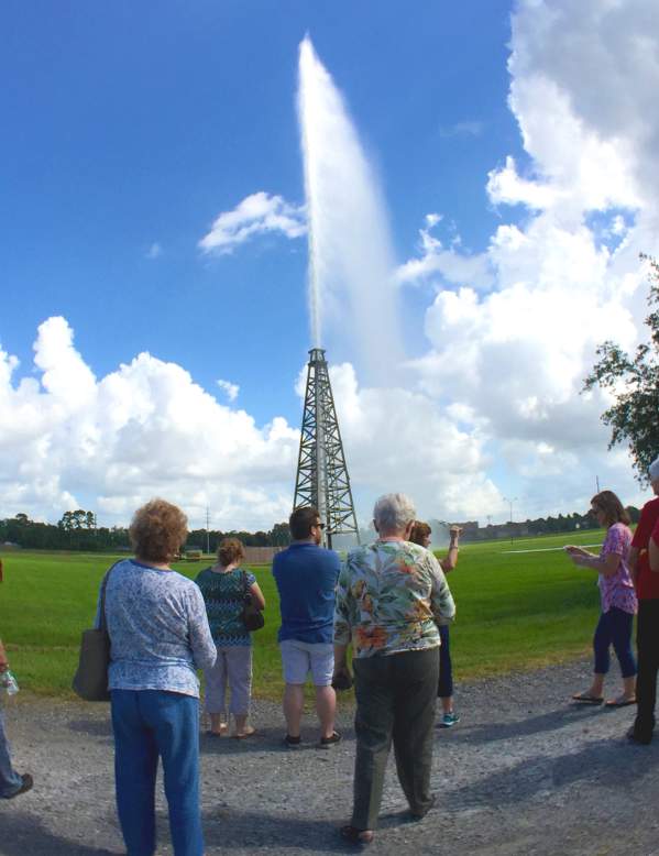 Spectators watch as the Spindletop Lucas gusher blows