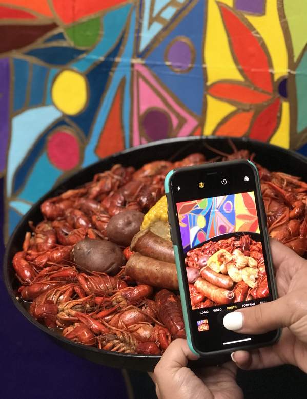 Phone taking a picture of a Beaumont crawfish dish