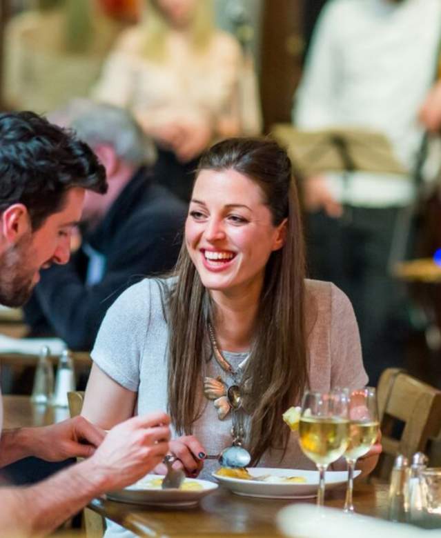 2 people eating pizza at Green Park Brasserie