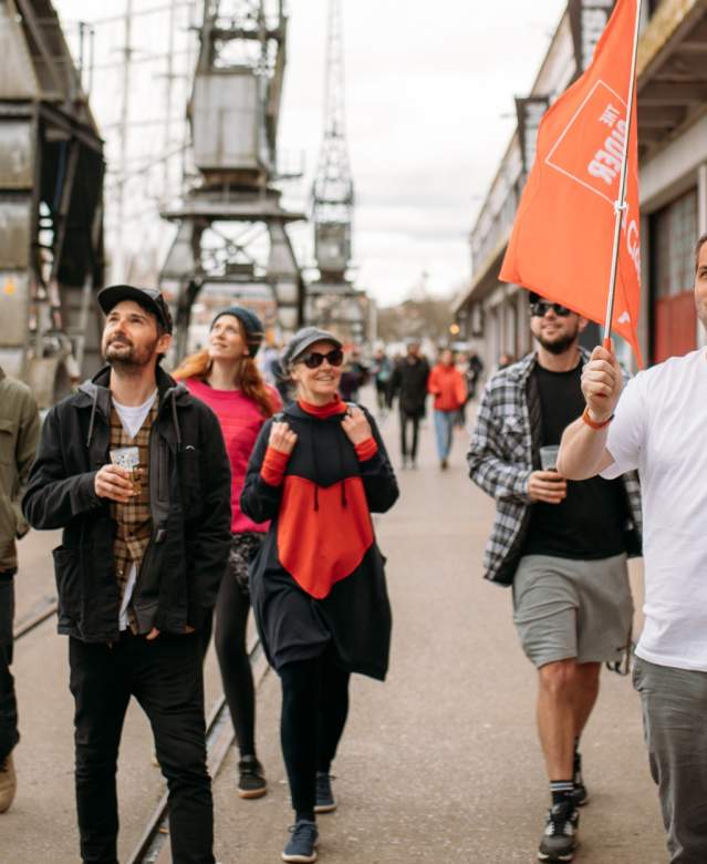 A group of people on the Cider Box walking tour of Bristol outside the M Shed local history museum on Bristol's Harbourside - credit Yuup