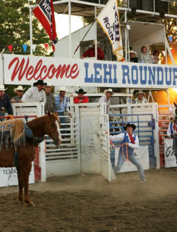 horses and riders in front of gate at Lehi Roundup rodeo