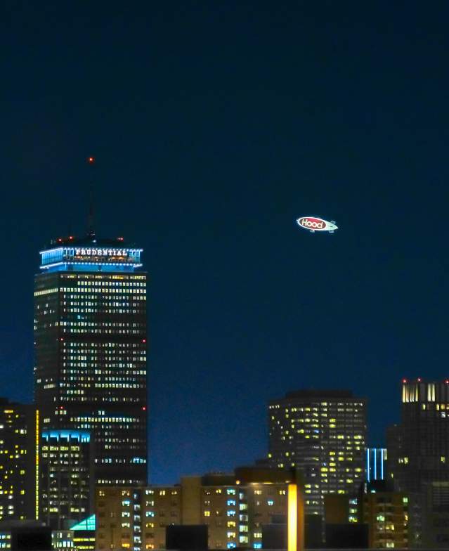 media gallery blimp over city