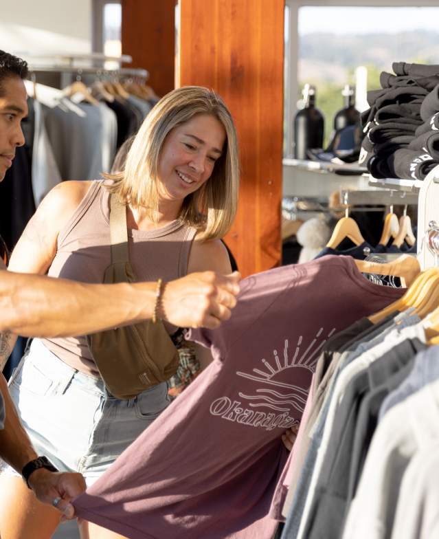 Couple exploring the apparel in the Kelowna Visitor Centre 1