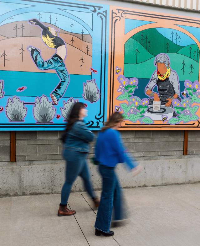 People walking in front of artwork outside of the Rotary Centre for the Arts