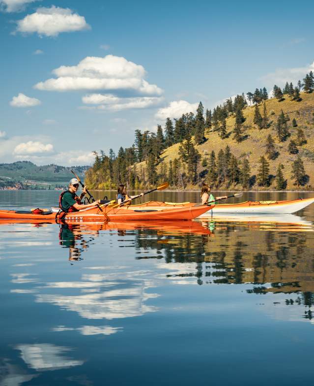 People Kayaking In A Lake In Kelowna, BC