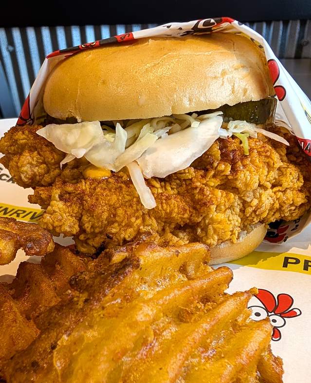 Photo of Hangry Joes restaurant featuring chicken sandwich with french fries and dipping sauce.
