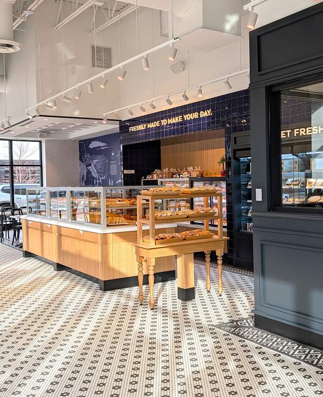 Inside of Paris Baguette bakery with couple seated at the left with sun shine splashing through the windows