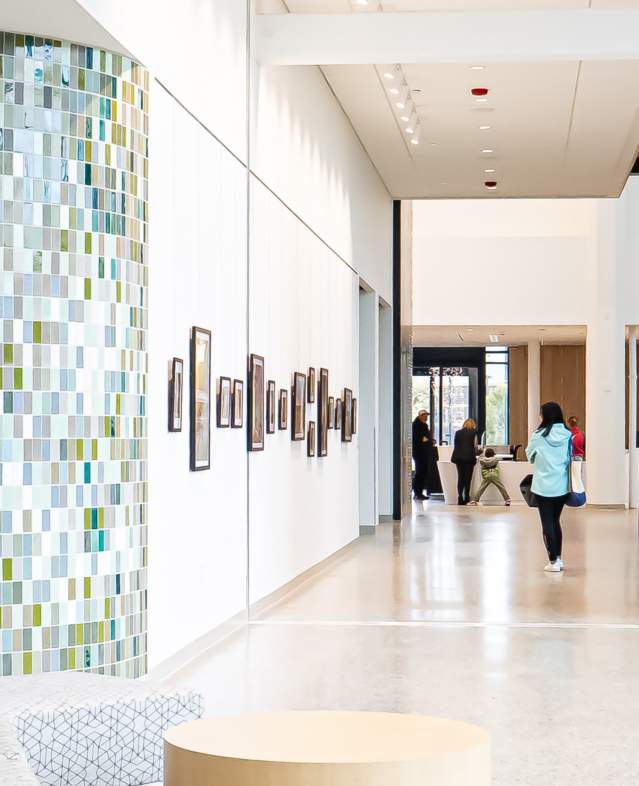 Woodbury Central Park photo with a guest gazing at lobby photos.