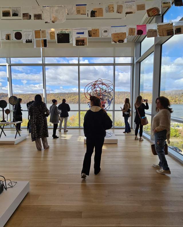 A gallery at the Hudson River Museum with large windows overlooking the Hudson River.