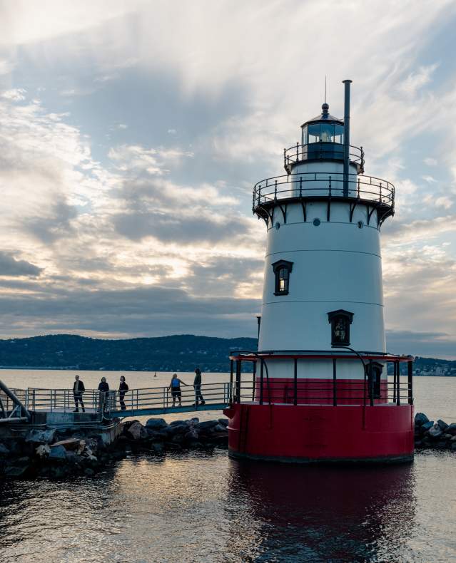 The sun sets over the Hudson River and Tarrytown lighthouse.