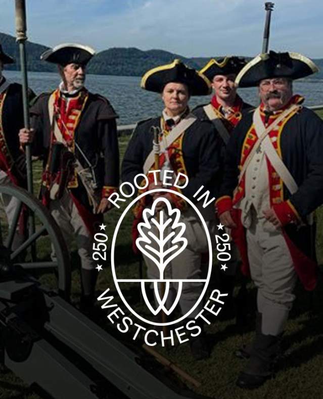 British soldiers standing behind a cannon