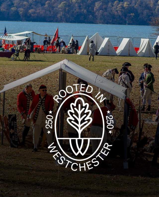 British campsite in foreground and tents along river in background