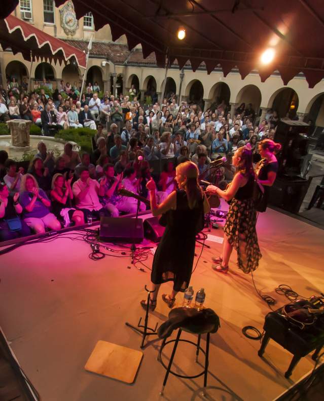Musicians play on a stage at night in front of a crowd in Caramoor's Venetian Theater.